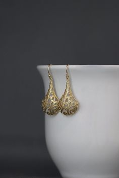 "Bold and detailed matte gold vermeil filigree charms simply dangle from gold vermeil balled earwires. These dramatic cut out charm earrings complete any outfit for daytime or evening. Gold charms: 19x32mm Total length of earrings: 1 3/4\" All gold is 18k gold vermeil. As the owner, maker, designer, and curator of this shop, I take great pride in providing you with jewelry that you will love to wear everyday, for special occasions, and for many years to come. Please read my Shop Policies which c Flower Earrings Gold, Gold Filigree Earrings, Judaica Jewelry, Gold Hamsa, Long Gold Earrings, Gold Dangle Earrings, Filigree Earrings, Gold Charms, Gold Filigree