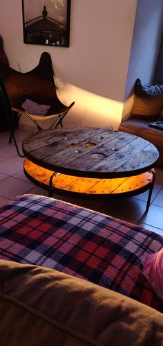 a coffee table made out of an old pallet wood board with lights on it