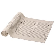 a rolled up yoga mat on top of a white surface with lines drawn across it