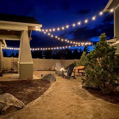 an outdoor patio with lights strung over it