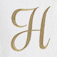 the letter h is made up of gold glitter