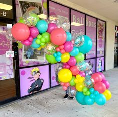 a bunch of balloons that are in front of a store