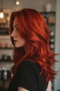 A woman's vibrant red-orange hair shimmering in natural light. Long Shag Red Hair, Natural Orange Hair Color, Orange Hair Inspiration, Copper Hair No Bleach, Copper And Burgundy Hair, Ginger Hair Updo, Spice Red Hair, Dark Red And Orange Hair, Bright Red Hairstyles