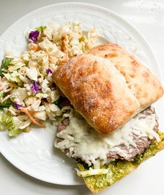 a sandwich and salad on a white plate