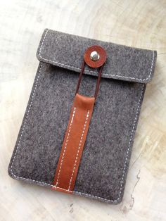 an ipad case with a brown leather strap