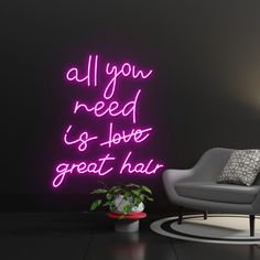 a neon sign that says all you need is love and great hair on the wall