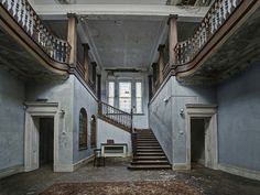 an abandoned building with stairs and windows