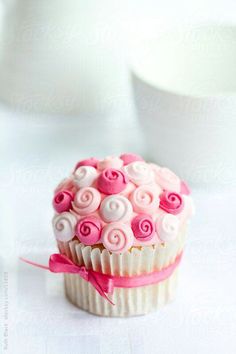 a cupcake decorated with pink and white icing