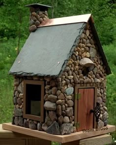 a small house made out of rocks and wood