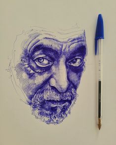 a pencil drawing of an old man's face on paper with a blue marker