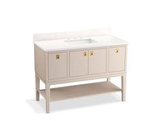 a white bathroom vanity with gold handles and drawers