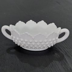 a white bowl sitting on top of a wooden table