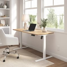 a laptop computer sitting on top of a wooden desk in front of a white chair