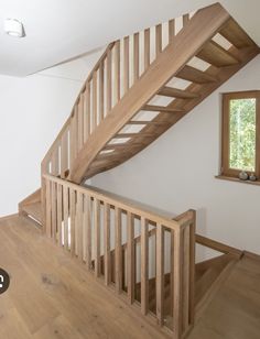 a wooden stair case in an empty room