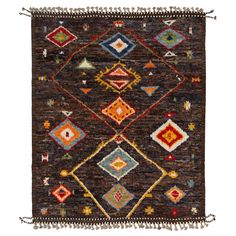 an old rug with many different colors and designs on it, including fringe trimmings