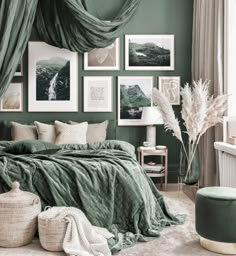 a bedroom with green walls and pictures hanging on the wall, along with wicker baskets