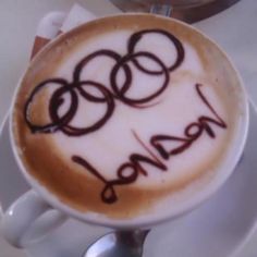 a cappuccino with the olympic symbol drawn on it