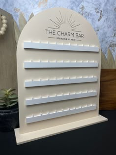 the charm bar sign on display in front of a wall