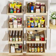 two wooden shelves filled with food and condiments on top of wood flooring