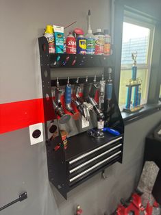 there is a tool rack with many tools on it