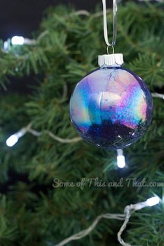 a glass ornament hanging from a christmas tree