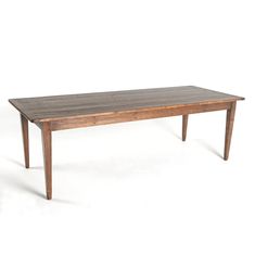 a wooden table sitting on top of a white floor