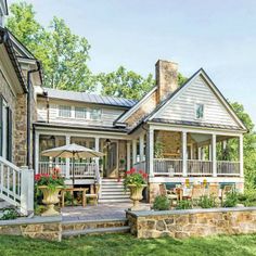 a stone house with an outdoor deck and patio