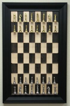 a framed chess board with pieces on it