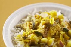 a white plate topped with rice and vegetables