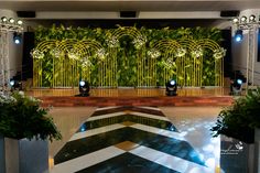 the stage is set up for an event with green walls and white flowers on it