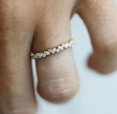 a woman's hand with a diamond ring on it, showing the inside of her finger