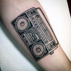 a black and white photo of a boombox tattoo on the arm