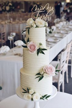 there is a wedding cake with flowers on it