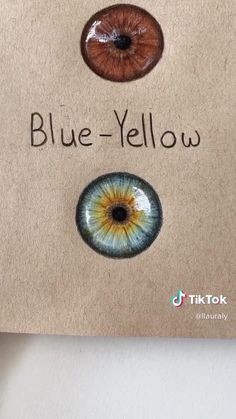 two different colored eyes are shown on a piece of paper with the words blue - yellow