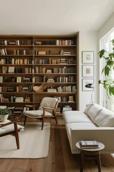 a living room filled with furniture and bookshelves