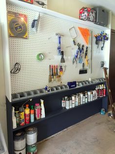 there are many tools on the wall in this garage