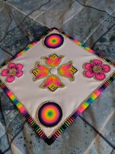 a white cloth with colorful designs on it