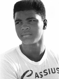 a black and white photo of a young man wearing a t - shirt with the word assus on it