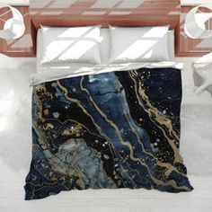 a bed covered in a blue and gold comforter