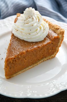 a slice of pumpkin pie with whipped cream on top