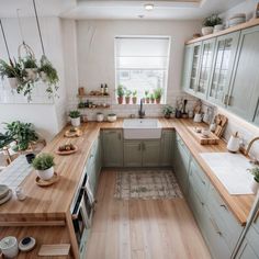 a kitchen filled with lots of counter top space and wooden flooring next to a window