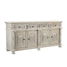 an old white wooden sideboard with carvings on the doors and drawers, isolated against a white background