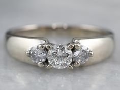 three stone diamond ring on white background