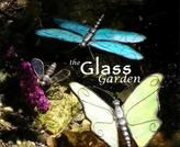 the glass garden book cover with three blue and white dragonflies on top of rocks