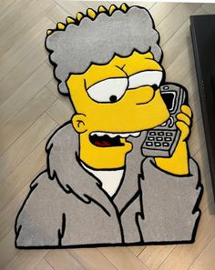 a rug with the image of homer simpson talking on a cell phone and making a face