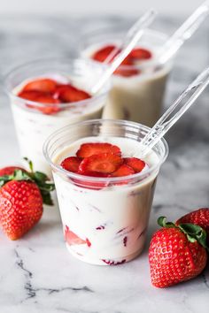 mexican strawberries and cream dessert in plastic cups with strawberries on the side for garnish