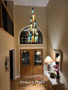 an entry way with a chandelier hanging from the ceiling