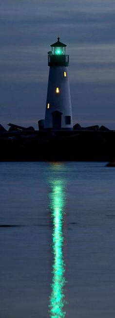 a light house sitting on top of a body of water