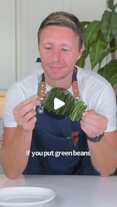 a man holding up some green beans in front of his face and the words if you put green beans on it