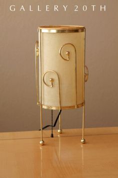 a small metal container sitting on top of a wooden table